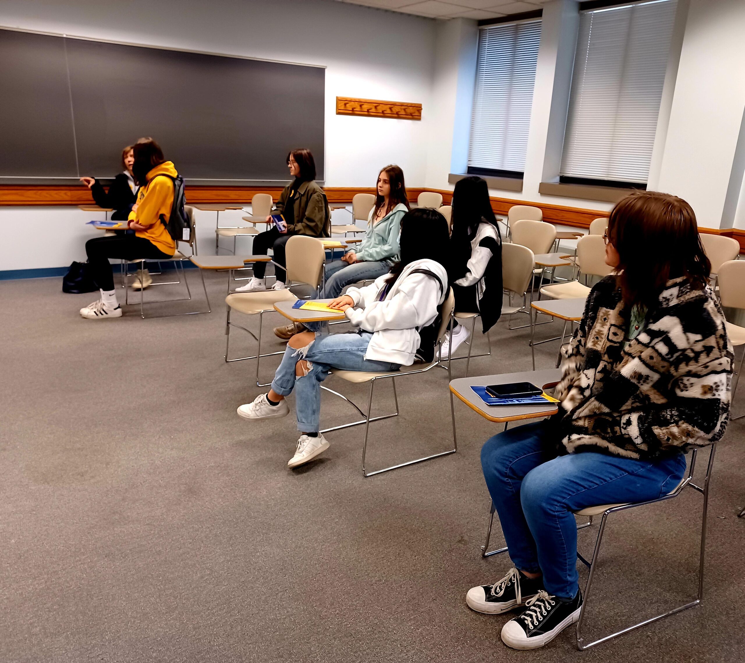 GB West students sitting in a classroom during Marquette University spring tour.