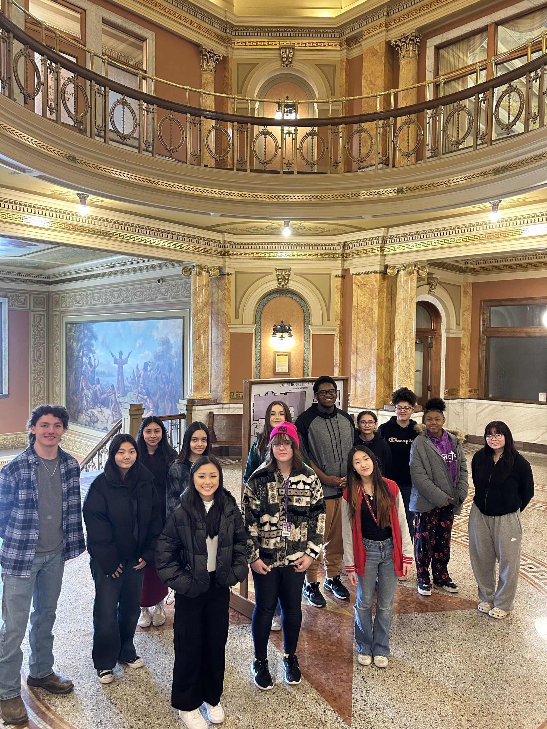 Green Bay West students stand in the lobby of the Brown County Courthouse.