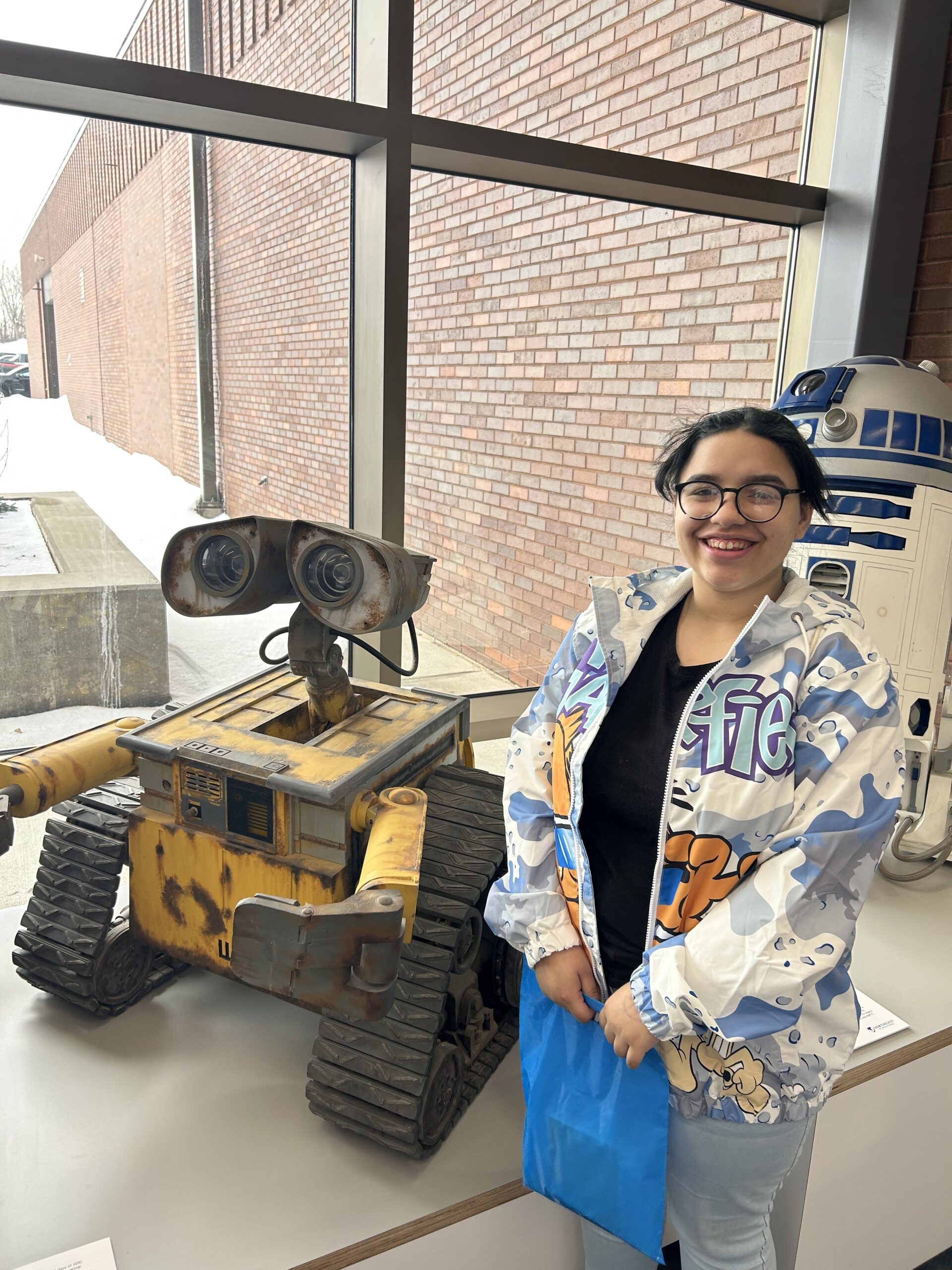Girl with WALLE and R2D2 robots at GB West engineering tour.