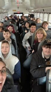 Green Bay West High School Band on school bus.