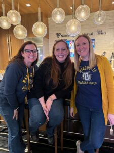 Staff from Green Bay West High School attend a Marquette University basketball game.